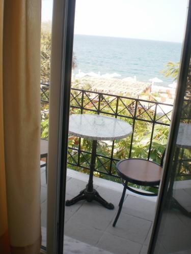 a balcony with a table and a view of the ocean at Dimitra in Petra