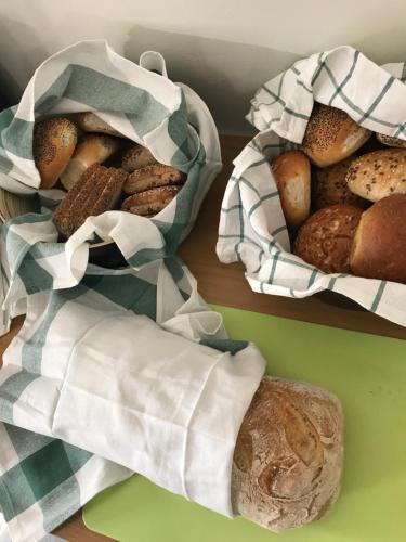two baskets of different types of bread on a table at Kalmar Hotell in Kalmar