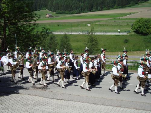 a group of musicians walking down a street at Apartments Residence Montana in Rasun di Sopra