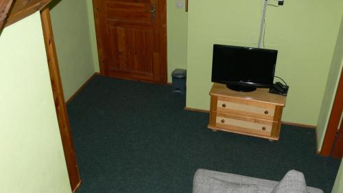 a living room with a tv on a wooden dresser at Salas-Partizanske in Partizánske