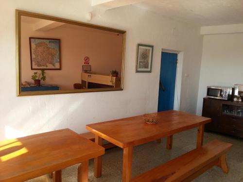 a living room with a table and a mirror at Hostal del Mar in A Guarda