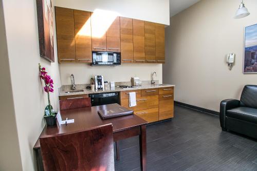 a small kitchen with a table and a couch at Pointe Plaza Hotel in Brooklyn