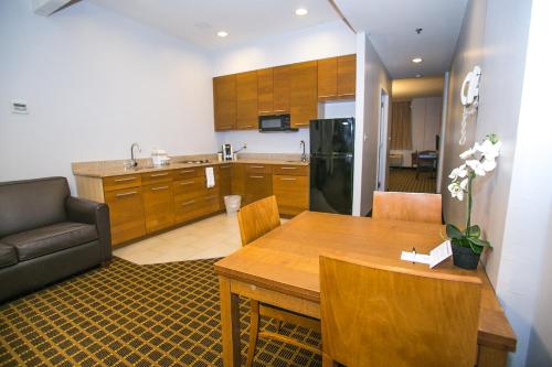 a kitchen and living room with a table and a couch at Pointe Plaza Hotel in Brooklyn