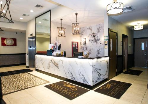 a lobby with a marble counter in a building at Pointe Plaza Hotel in Brooklyn