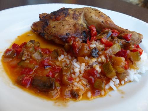 a plate of food with rice and a piece of meat at Hostal Vall D'Aneu by Arcas & Sambola in Esterri d'Àneu