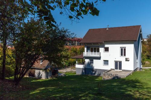 a white house with a brown roof at Apartment Snježana in Slunj