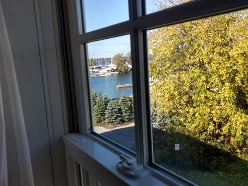 a window with a view of a body of water at Harbor House Inn in Sackets Harbor