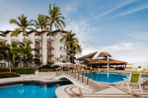 a resort with a swimming pool and a hotel at Buenaventura Grand Hotel & Great Moments - All Inclusive in Puerto Vallarta
