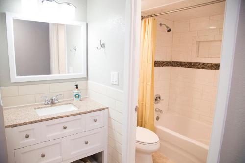 a bathroom with a sink and a toilet and a shower at Daytona Beach Club Studios! in Daytona Beach