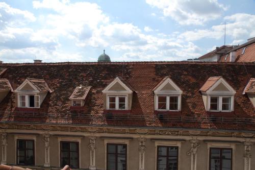 a brick building with windows on top of it at Apartment Joanneum in Graz