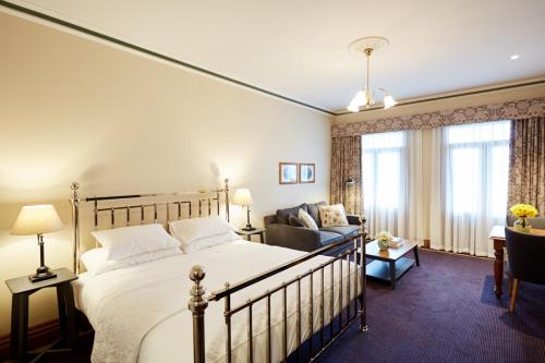 a bedroom with a bed and a couch in a room at The Terrace at The Settlement in Cranbourne