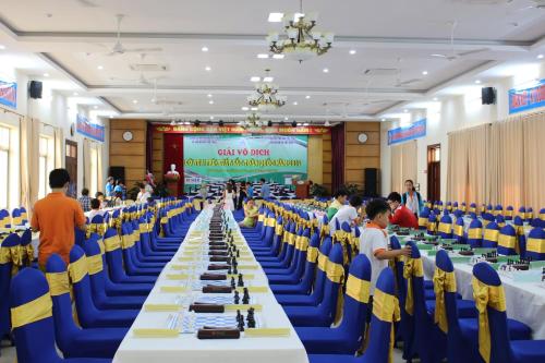a large banquet hall with blue chairs and long tables at Hanvet Hotel Do Son in Ðố Sơn