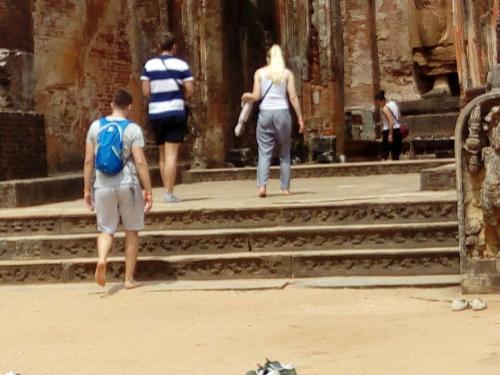 a group of people walking up steps in a building at My Home Guest in Polonnaruwa