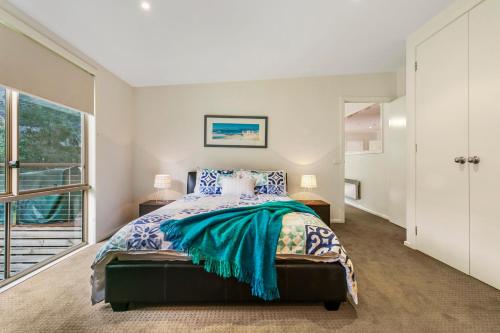 a bedroom with a bed and a large window at Bonnie Blairgowrie in Blairgowrie