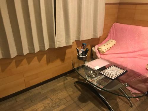 a glass table with a glass chair and a glass coffee table with a glass table at Hotel Vegas (Adult Only) in Sapporo