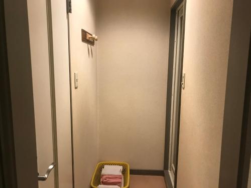 a bathroom with a walk in shower with a basket at Hotel Vegas (Adult Only) in Sapporo