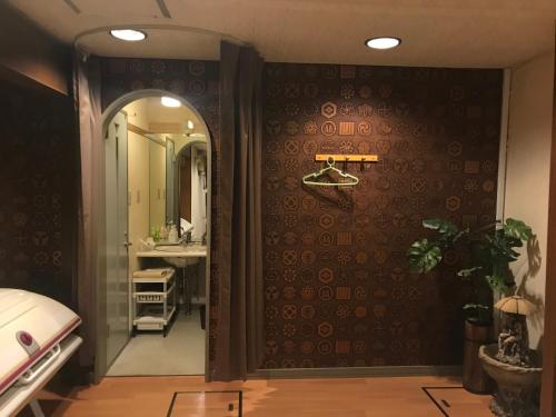 a bathroom with a large mirror and a sink at Hotel Vegas (Adult Only) in Sapporo