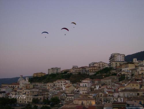 a group of three kites flying over a city at Piccolo Grand Hotel in Pizzo