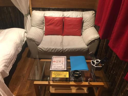 a couch with two red pillows on a table at Hotel Vegas (Adult Only) in Sapporo