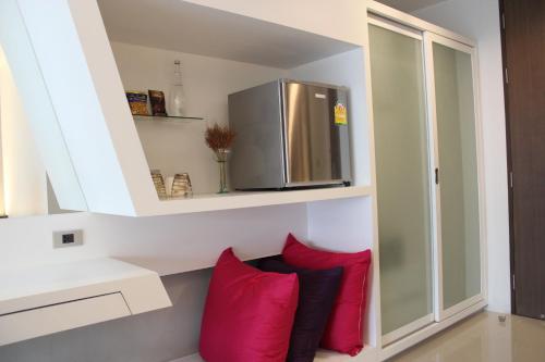 eine Küche mit roten Kissen und einem Kühlschrank in der Unterkunft Nine Forty One Hotel in Bangkok