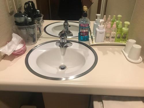 a bathroom counter with a sink and a mirror at Hotel Vegas (Adult Only) in Sapporo