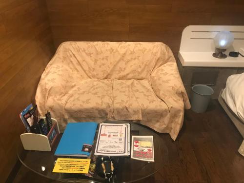 a glass table with items on top of a bed at Hotel Vegas (Adult Only) in Sapporo