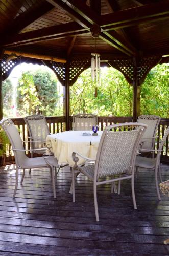 a table and chairs on a wooden deck at Dallas Residence in Varna City