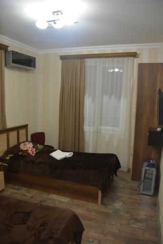 a hotel room with a bed and a window at City Hotel in Tbilisi City