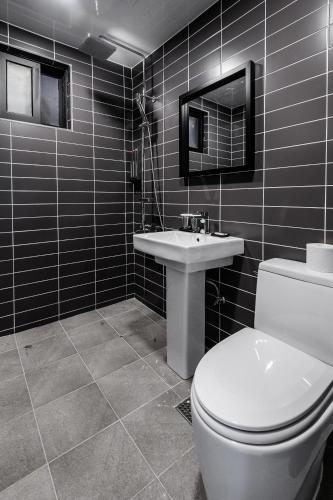 a bathroom with a toilet and a sink at Hotel Hyggelig in Busan