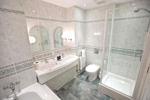 a bathroom with a sink toilet and a shower at Marygreen Manor in Brentwood