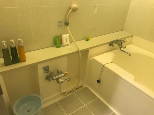 a bathroom with a shower and a tub and a sink at Hotel Vegas (Adult Only) in Sapporo