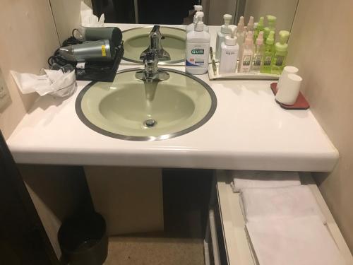 a bathroom counter with a sink and a mirror at Hotel Vegas (Adult Only) in Sapporo