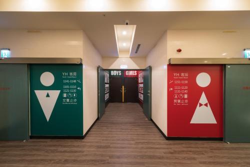 a hallway in a hospital with doors and signs at Skyone Hotel in Kaohsiung
