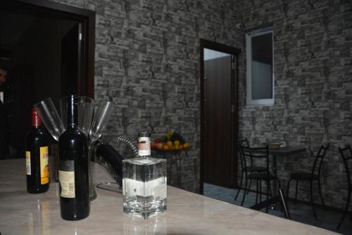 two bottles of wine sitting on top of a table at City Hotel in Tbilisi City