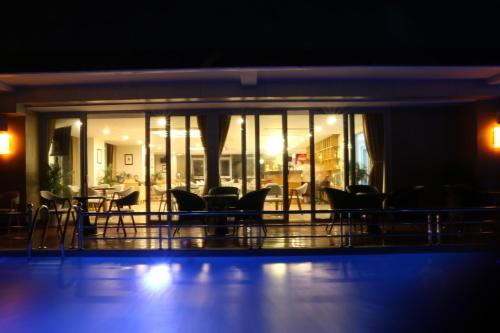 a room with chairs and tables at night at Vinh Hoang Hotel in Dong Hoi