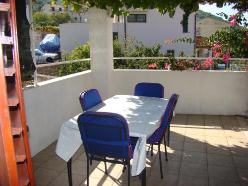 a table and chairs sitting on a patio at Studio Apartments Kuljiš in Vis