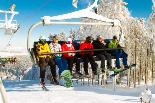 a group of people sitting on a ski lift at Berghotel Natura Bed & Breakfast in Winterberg