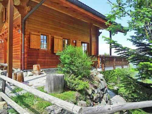 a log cabin with a fence in front of it at Comfortable Holiday Home with Fireplace in Vex in Les Collons