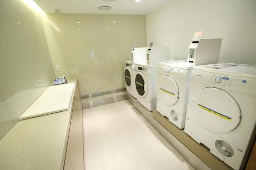 a laundry room with a washer and dryer at Hotel PJ Myeongdong in Seoul