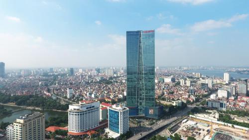a view of a city with a tall skyscraper at Lotte The Residence in Hanoi
