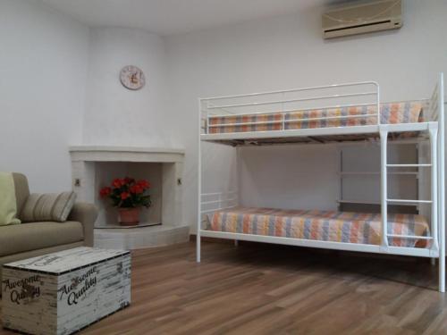 a living room with a bunk bed and a couch at fiori e massi in Ostuni