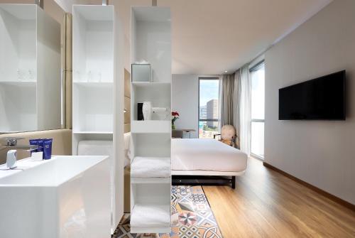 a hotel room with a bed and a television at Hotel SB Glow 4 Sup in Barcelona