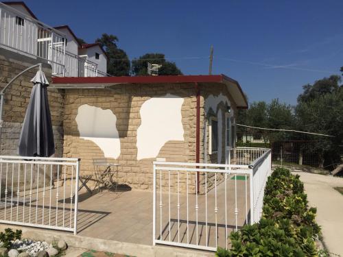 a small building with a gate and an umbrella at Zia Bi Bed and Breakfast in Naples