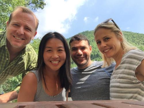 a group of three people posing for a picture at Moganshan Solvang Village Boutique Hotel in Deqing
