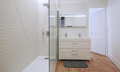 a bathroom with a sink and a glass shower at T4 du Languedoc in Toulouse