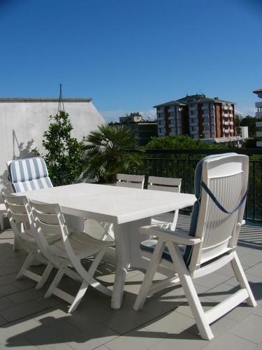 a white picnic table and two chairs on a roof at Hotel Serena in Grado
