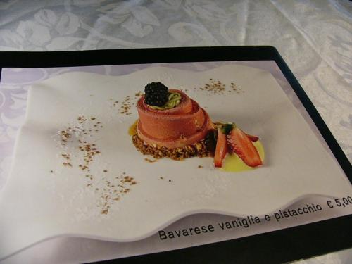 a dessert on a plate with a blackberry on it at Hotel Serena in Grado