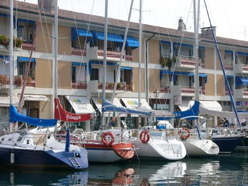 a group of boats docked in front of a building at Hotel Serena in Grado