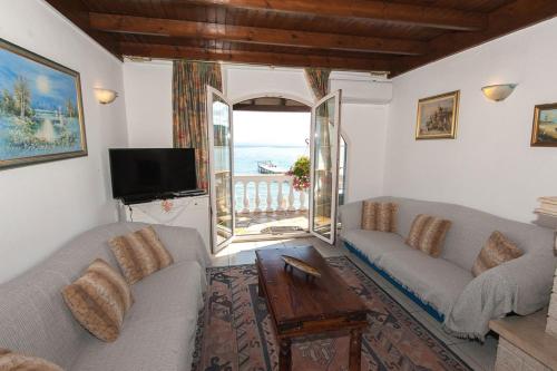 a living room with two couches and a view of the ocean at Sweet Memories Beach Houses in Mesongi