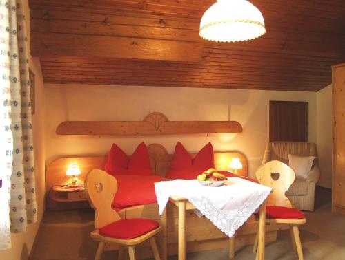 a room with a table and chairs and a bed at Haus Elfi in Wagrain